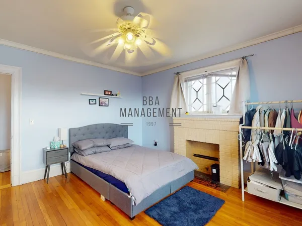 a bedroom with a bed and a fireplace