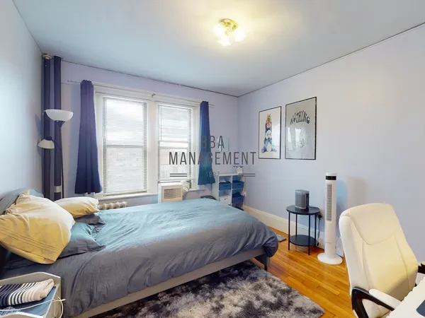 a bedroom with bed chair and window