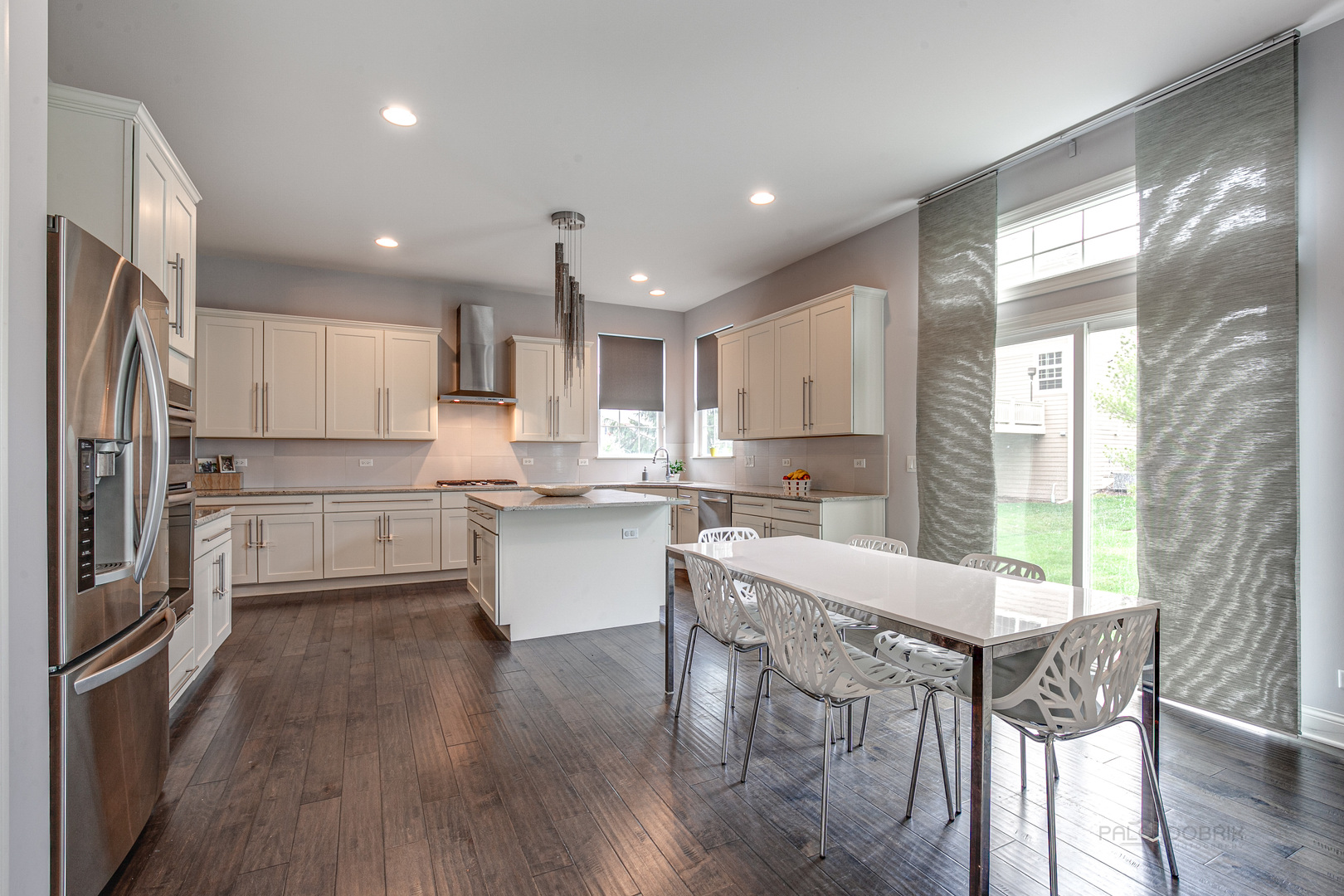 1120 Ashley Lane Inverness, IL 60010 - Photo 11 of 46 a kitchen with a table chairs refrigerator microwave and cabinets