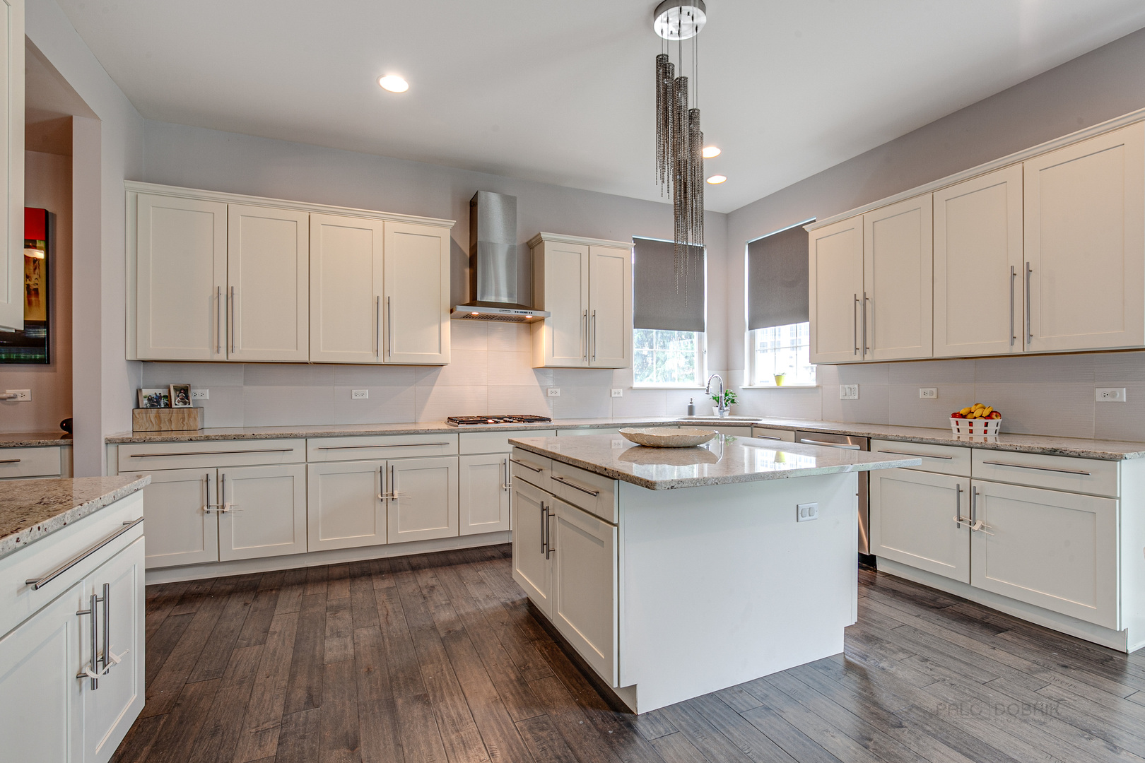 1120 Ashley Lane Inverness, IL 60010 - Photo 12 of 46 a kitchen with kitchen island granite countertop a sink cabinets and wooden floor