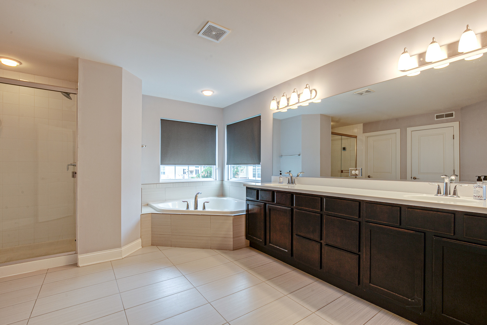 1120 Ashley Lane Inverness, IL 60010 - Photo 23 of 46 a spacious bathroom with a tub sink shower and mirror