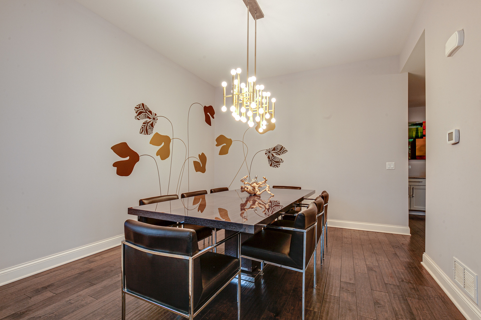 1120 Ashley Lane Inverness, IL 60010 - Photo 6 of 46 a dining room with wooden floor a chandelier a wooden table and chairs