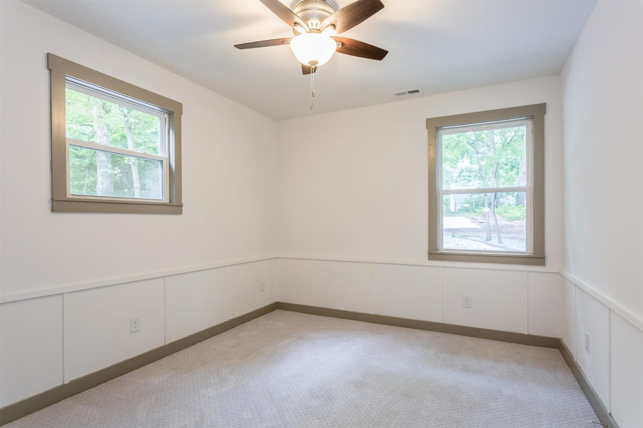 409 Stacy Street Raleigh, NC 27607 - Photo 24 of 25 Personally this bedroom would be my home office, due to its extremely convenient location next to the back door adjacent to parking. Clients could visit without traipsing through your whole house, but may strain their neck as the kitchen catches eyeballs. Bedroom