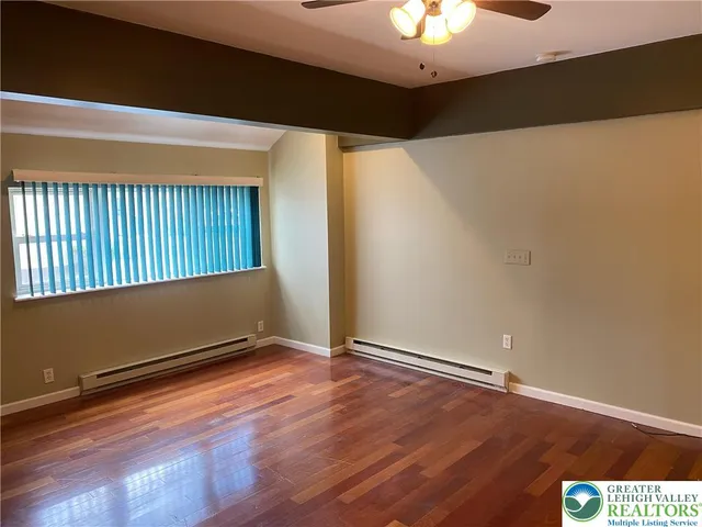 a kitchen with a refrigerator a stove a sink dishwasher and a dining table with wooden cabinet