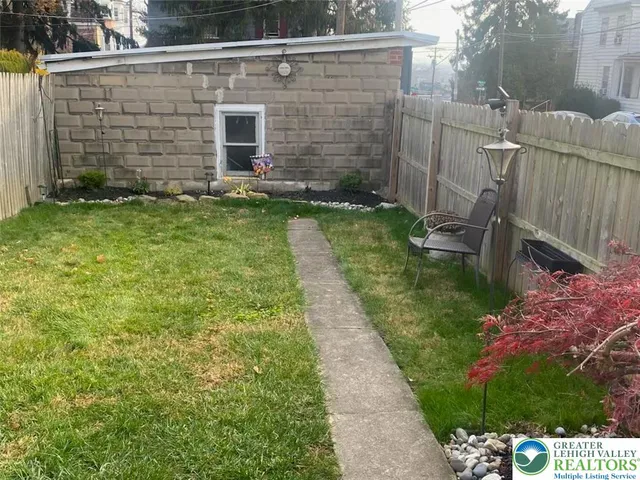 a kitchen with stainless steel appliances a refrigerator a stove a sink a center island and wooden floor