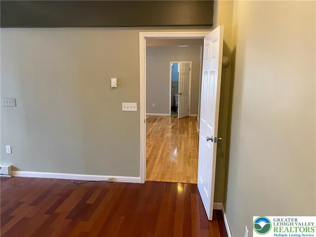 a room with furniture a chandelier and wooden floor