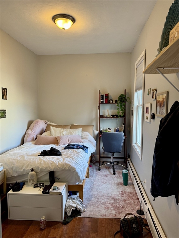 224 Chelsea Street Boston, MA 02128 - Photo 13 of 26 a bedroom with a bed and furniture