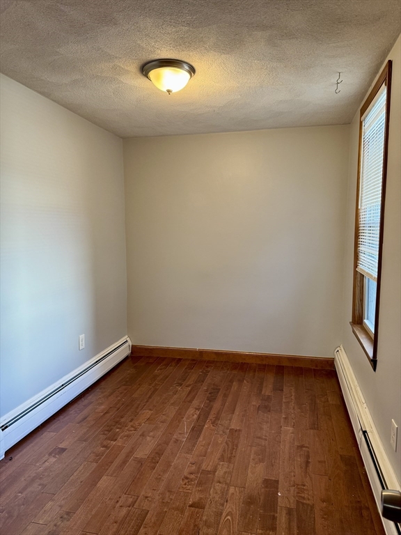 224 Chelsea Street Boston, MA 02128 - Photo 16 of 26 an empty room with wooden floor and windows