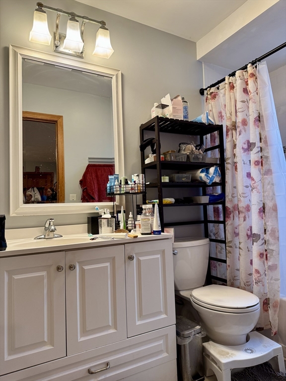 224 Chelsea Street Boston, MA 02128 - Photo 20 of 26 a bathroom with a toilet a sink and a mirror