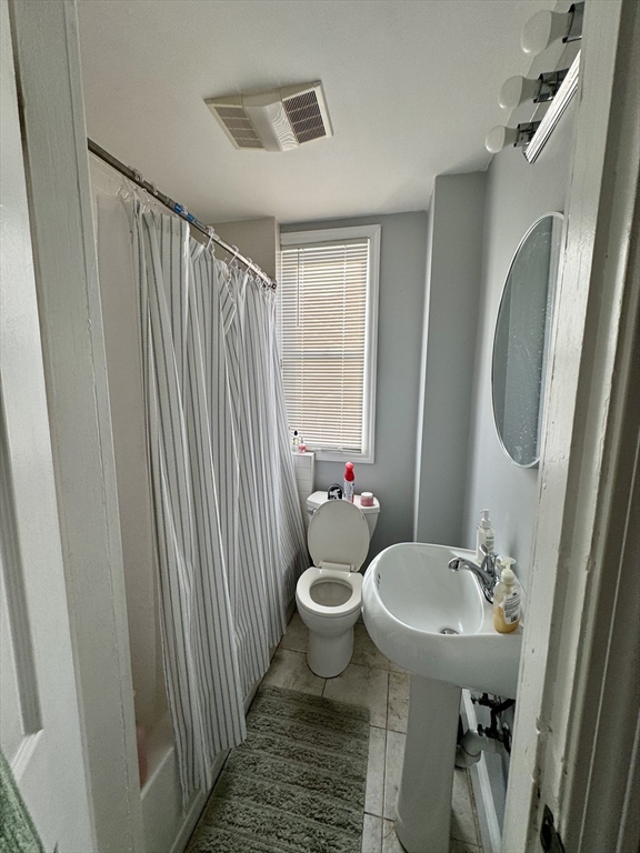 224 Chelsea Street Boston, MA 02128 - Photo 21 of 26 a bathroom with a sink a toilet and a mirror
