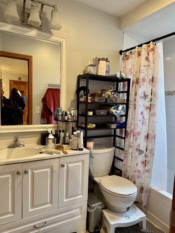 224 Chelsea Street Boston, MA 02128 - Photo 22 of 26 a bathroom with a toilet sink and mirror
