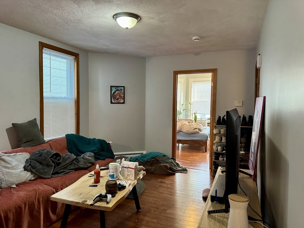 224 Chelsea Street Boston, MA 02128 - Photo 7 of 26 a living room with furniture and wooden floor