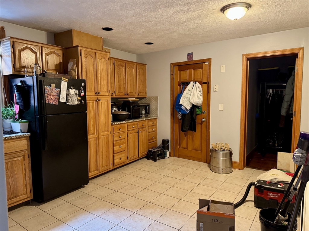 224 Chelsea Street Boston, MA 02128 - Photo 10 of 26 a bedroom with bed and cabinets