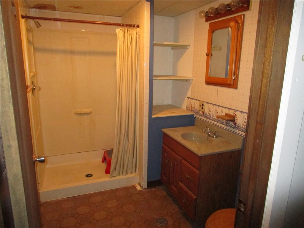 410 Hazen Road Sharpsville, PA 16150 - Photo 20 of 22 a bathroom with a sink a mirror and a shower