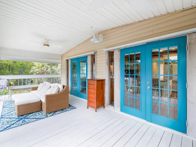 a bedroom with furniture and large window