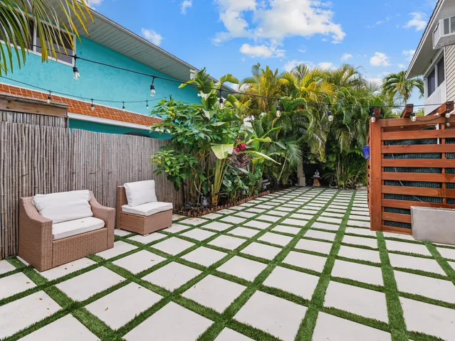 a view of a backyard with sitting area