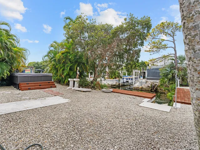 a row of palm trees in front of a house
