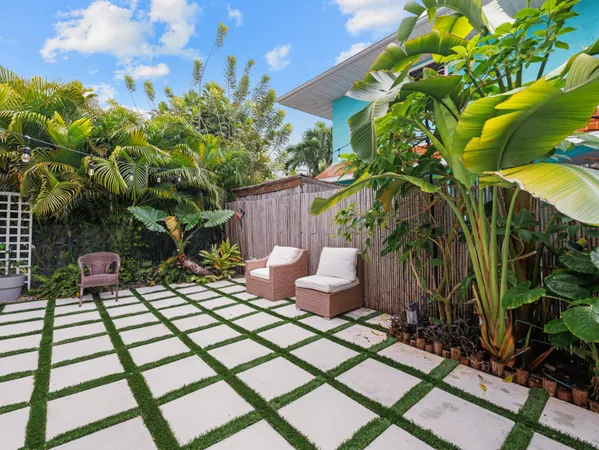 a living room with furniture a flat screen tv and a wall painting