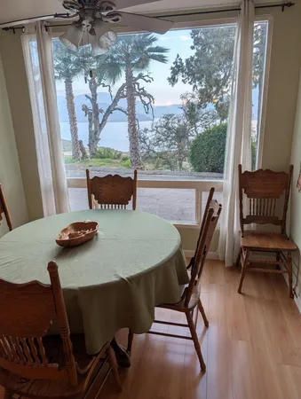 a view of a dining room with furniture window and outside view