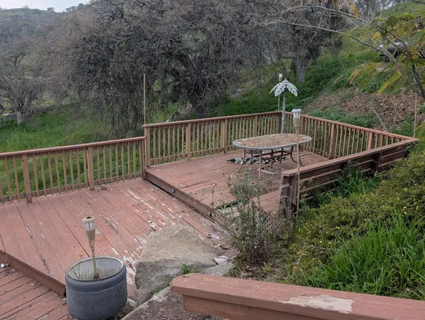 a view of balcony with wooden floor and outdoor seating