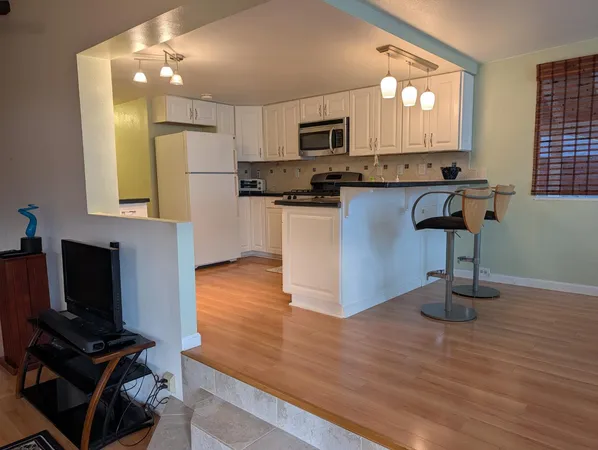 a kitchen with stainless steel appliances a stove top oven and a refrigerator