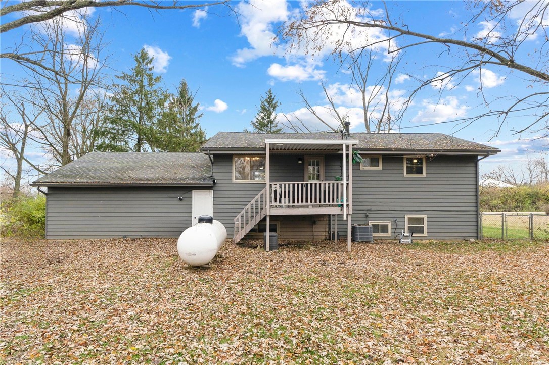 8180 Manning Road Germantown, OH 45327 - Photo 32 of 39 A classic grey-sided home featuring a cozy deck, nestled amidst a tranquil, expansive yard.