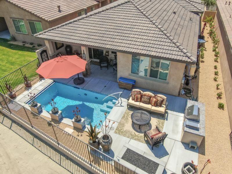 a view of a patio with couches chairs and a potted plant