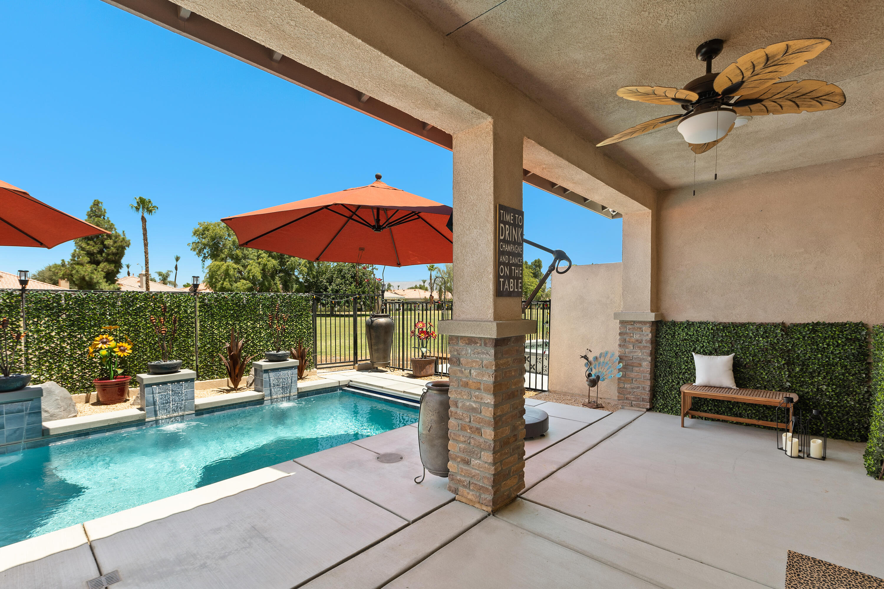 82700 Burnette Drive Indio, CA 92201 - Photo 23 of 38 a view of a patio with a table and chairs under an umbrella