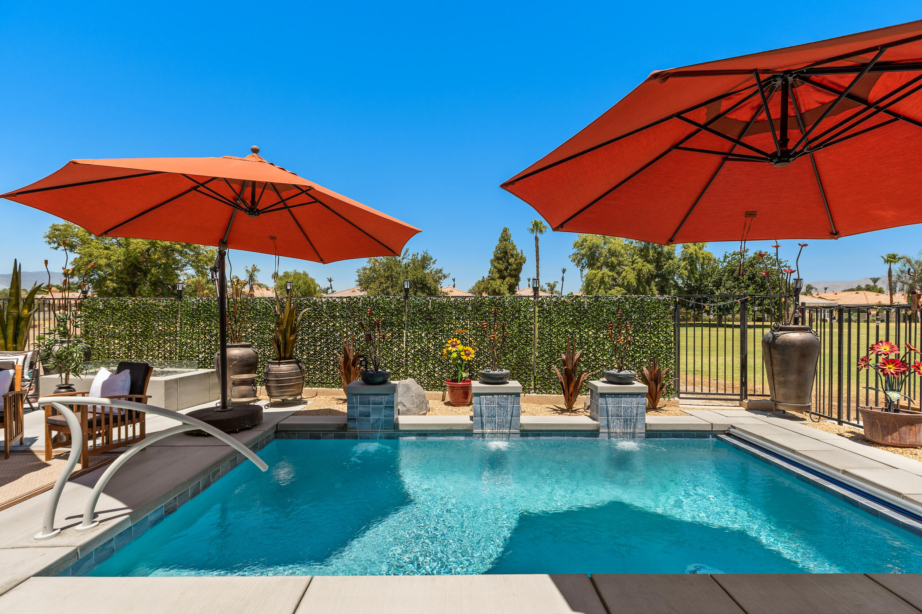 82700 Burnette Drive Indio, CA 92201 - Photo 24 of 38 a view of pool with lawn chairs under an umbrella
