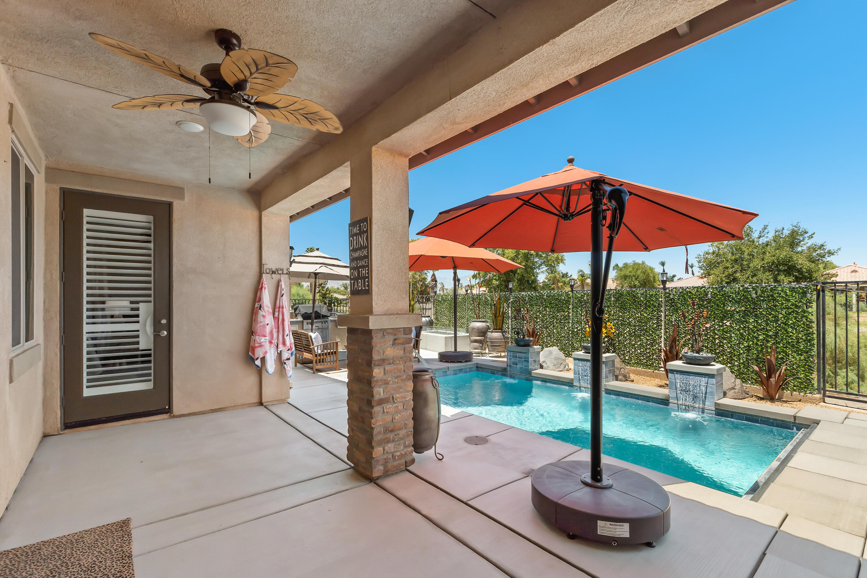 82700 Burnette Drive Indio, CA 92201 - Photo 25 of 38 a view of a patio with a table and chairs under an umbrella