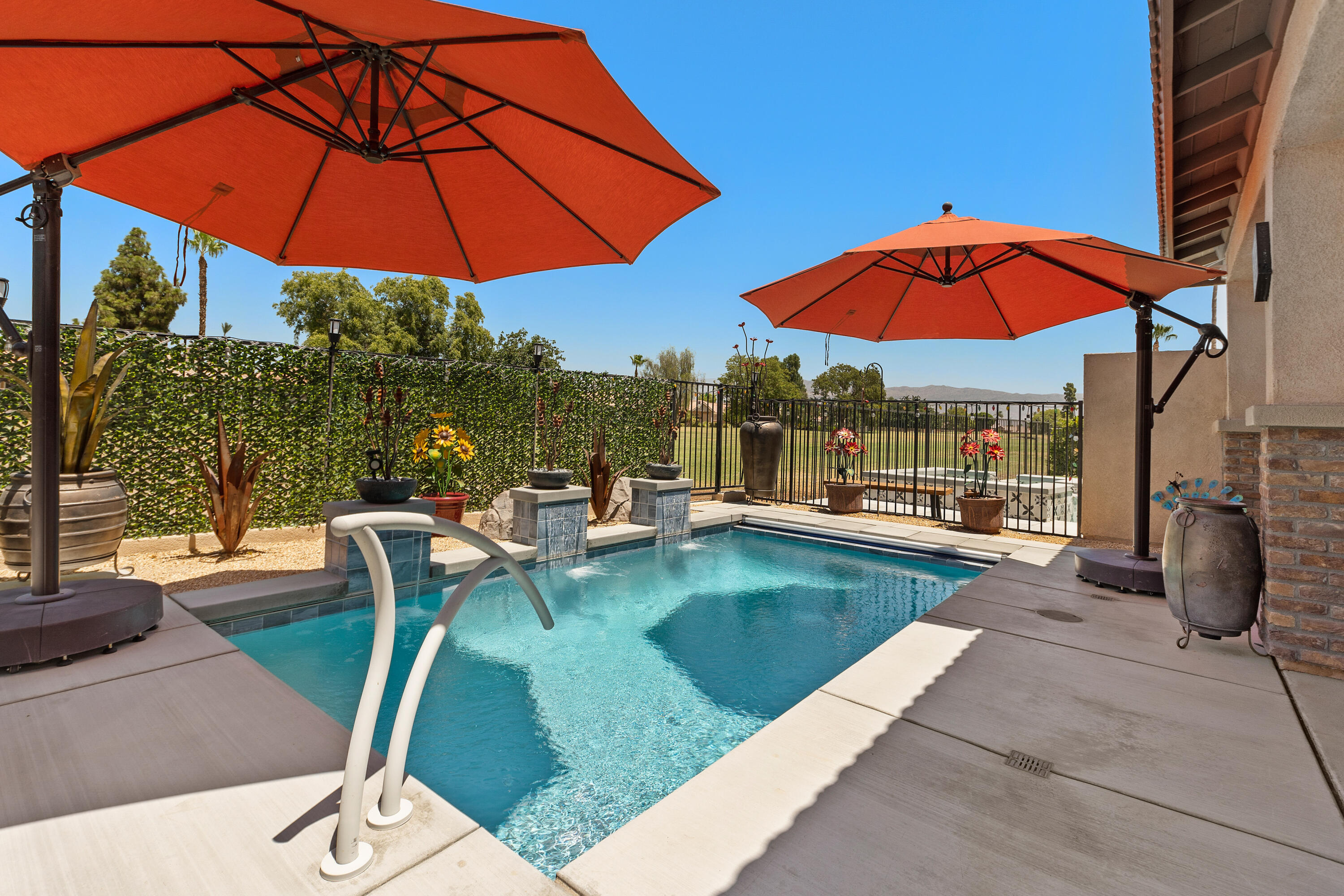 82700 Burnette Drive Indio, CA 92201 - Photo 29 of 38 a view of swimming pool with a table and chairs under an umbrella