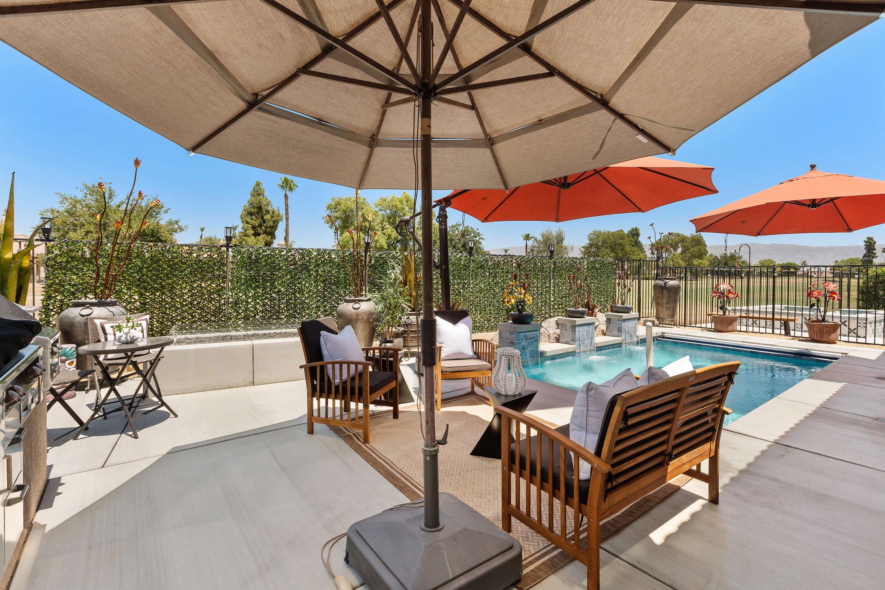 82700 Burnette Drive Indio, CA 92201 - Photo 30 of 38 a view of a patio with a table and chairs under an umbrella