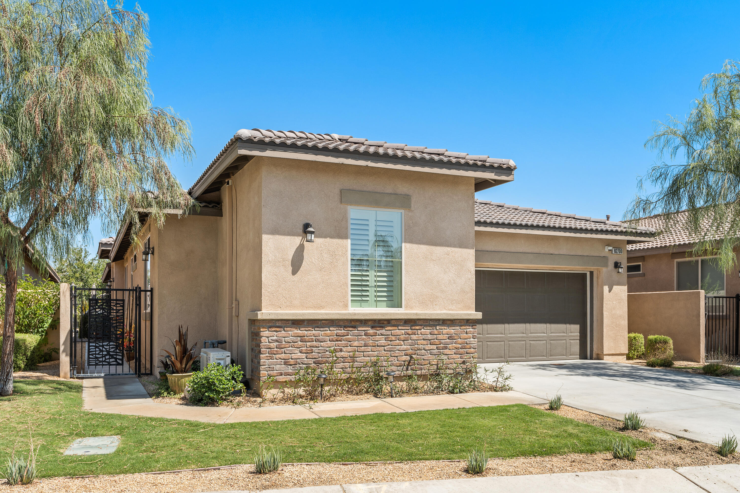 82700 Burnette Drive Indio, CA 92201 - Photo 34 of 38 a front view of a house with garden