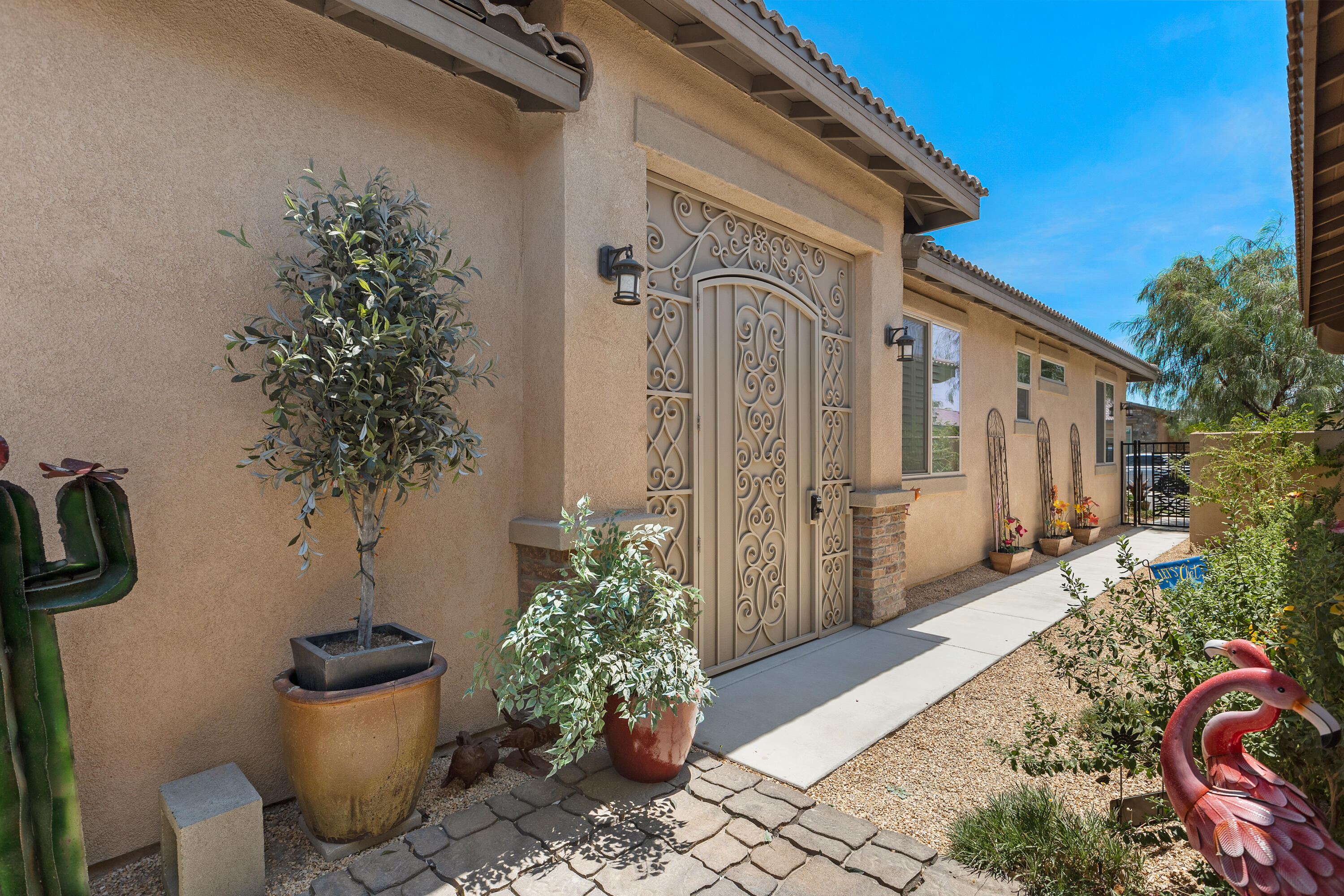 82700 Burnette Drive Indio, CA 92201 - Photo 37 of 38 a view of a porch with furniture and potted plants