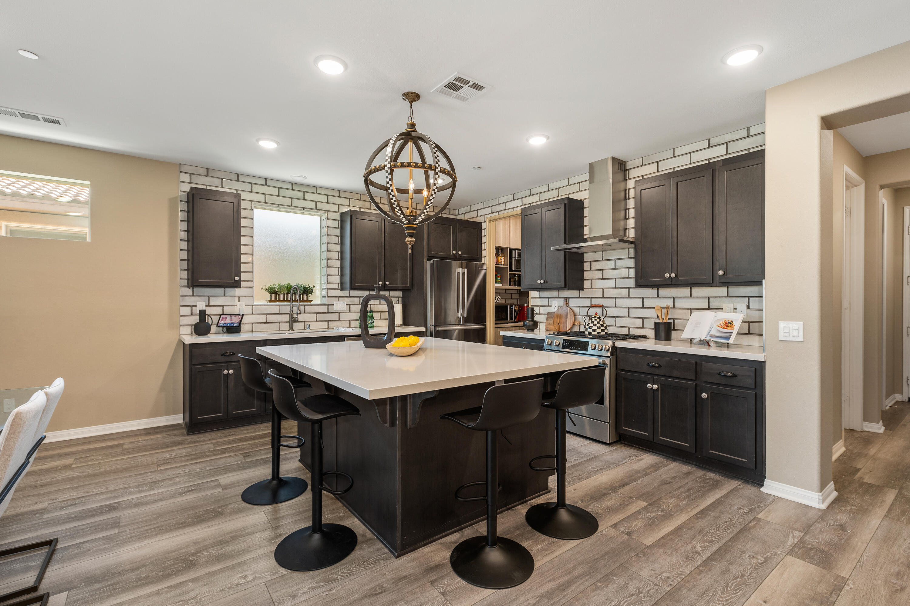 82700 Burnette Drive Indio, CA 92201 - Photo 4 of 38 a kitchen with a sink cabinets and wooden floor