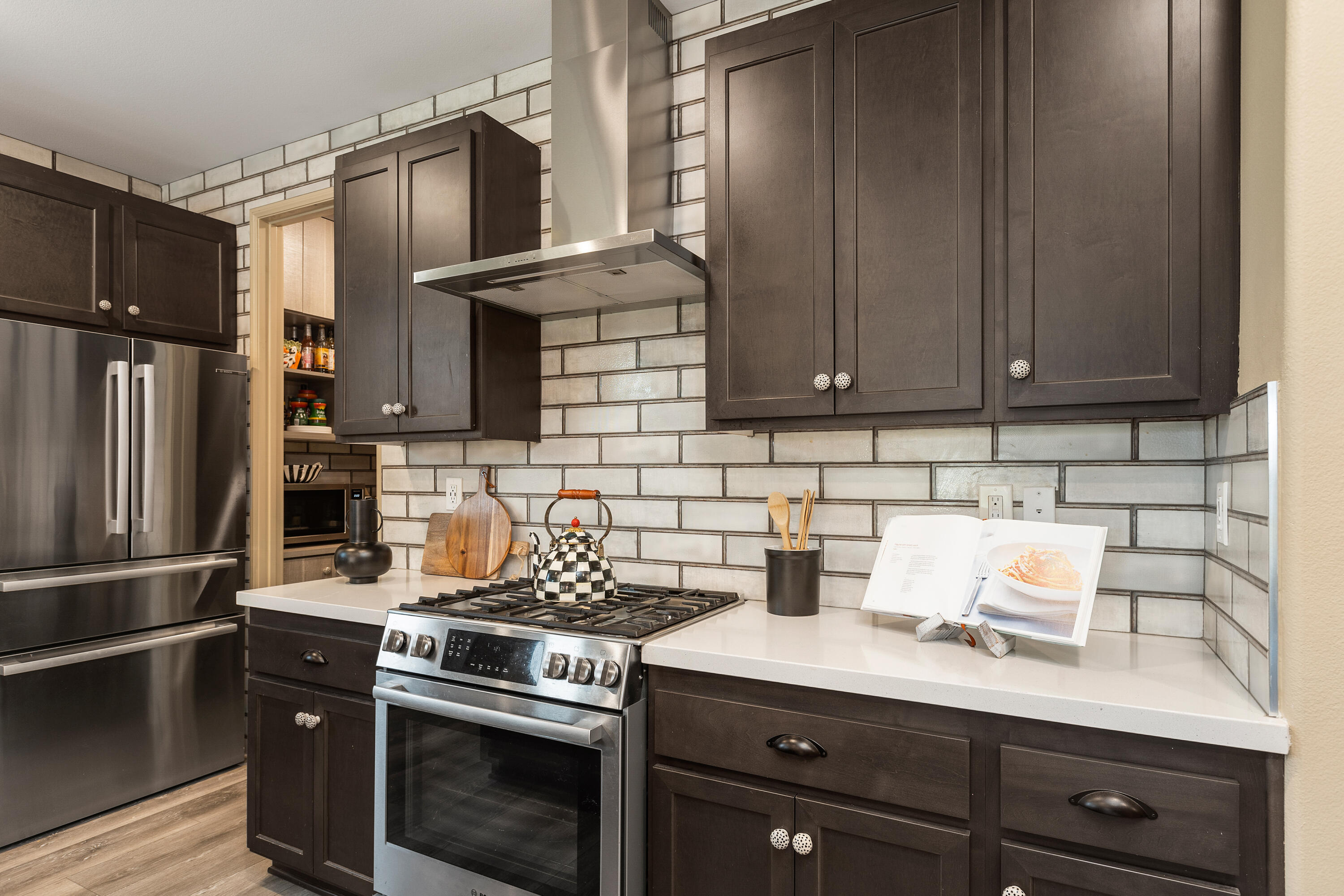 82700 Burnette Drive Indio, CA 92201 - Photo 5 of 38 a kitchen with stainless steel appliances a stove a refrigerator and cabinets