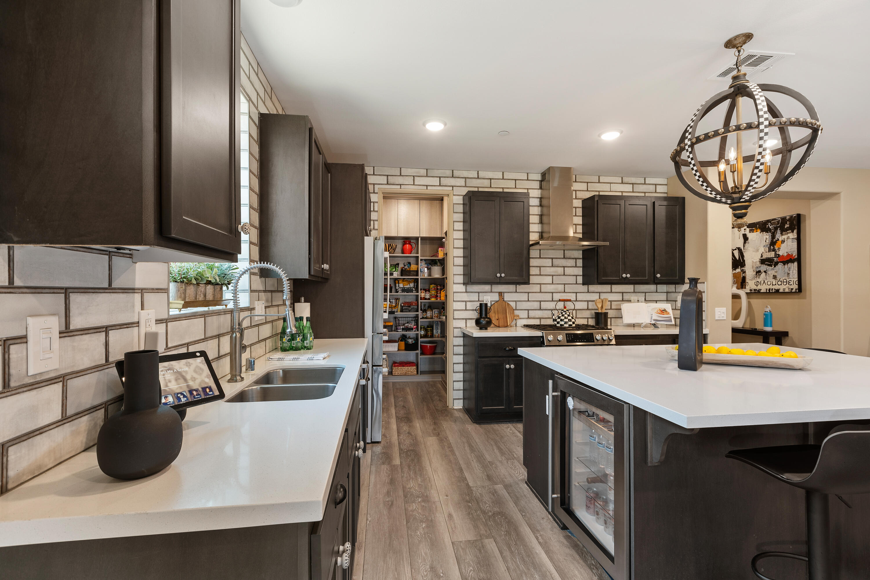 82700 Burnette Drive Indio, CA 92201 - Photo 7 of 38 a kitchen with stainless steel appliances granite countertop a sink counter space and a stove top oven