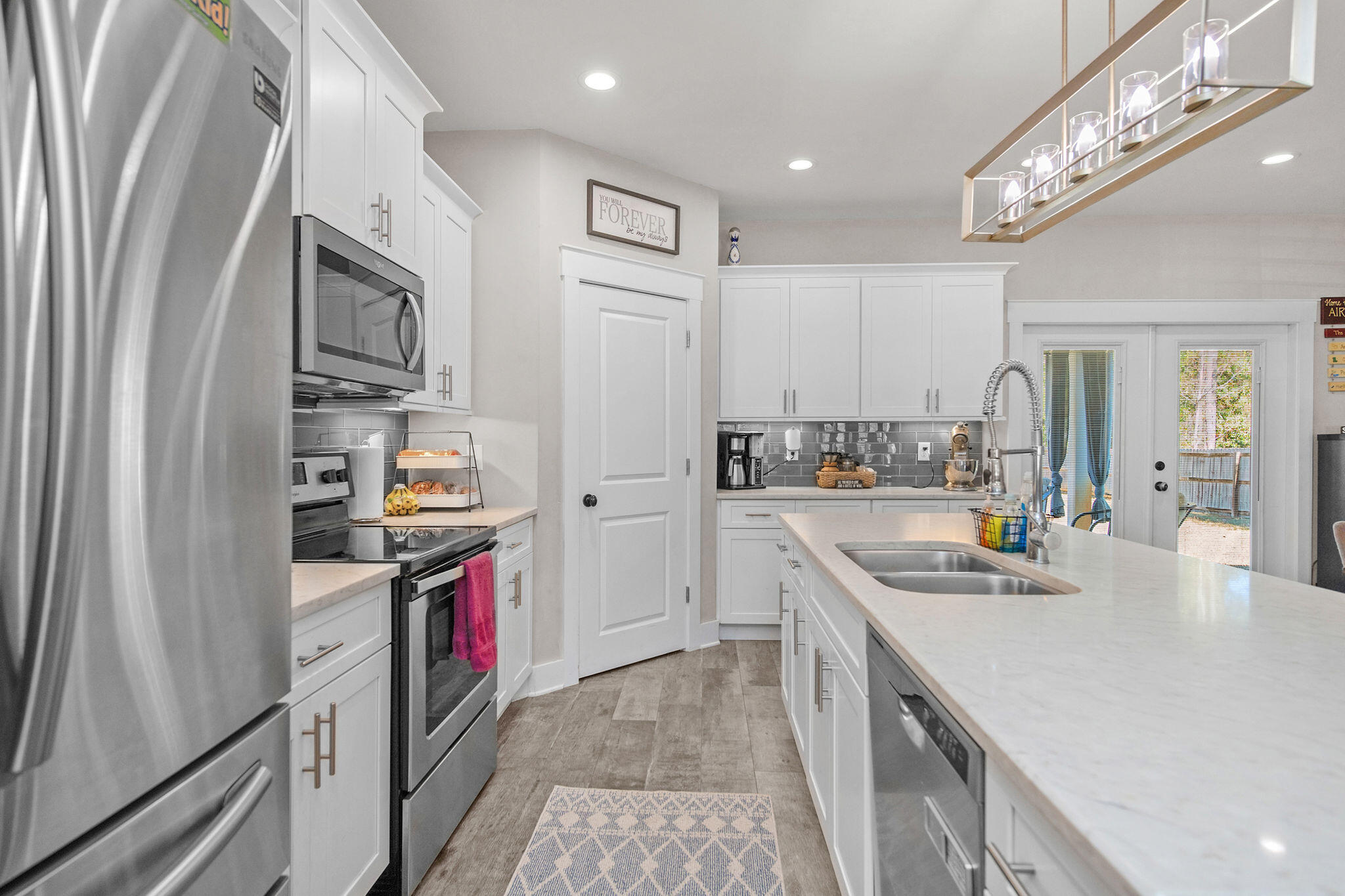8914 Timber Lane Navarre, FL 32566 - Photo 12 of 40 a kitchen with stainless steel appliances granite countertop a refrigerator and a stove