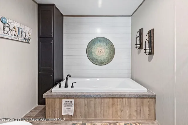 a bathroom with a granite countertop sink a mirror and vanity