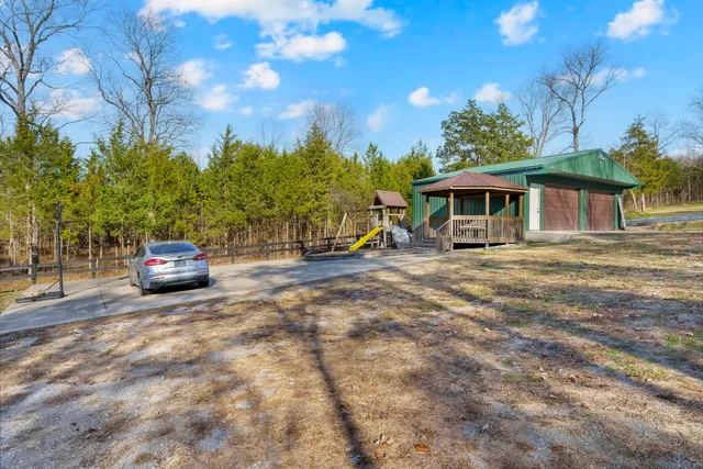 a view of a house with a yard porch and furniture