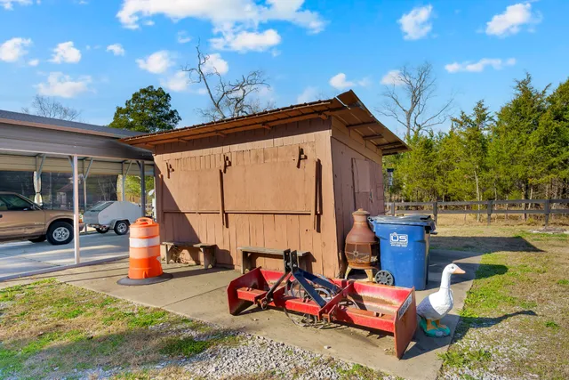 a view of swimming pool with a bench and trees around