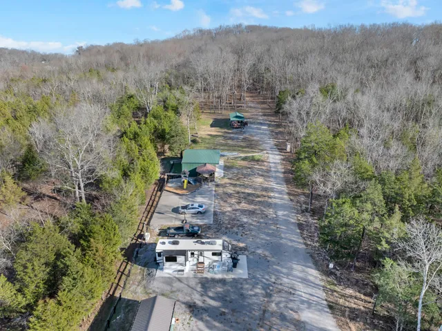 a view of a yard with wooden fence
