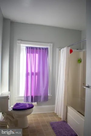 a view of a room with window and carpet