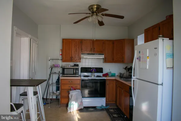 a kitchen with stainless steel appliances a stove a refrigerator and cabinets
