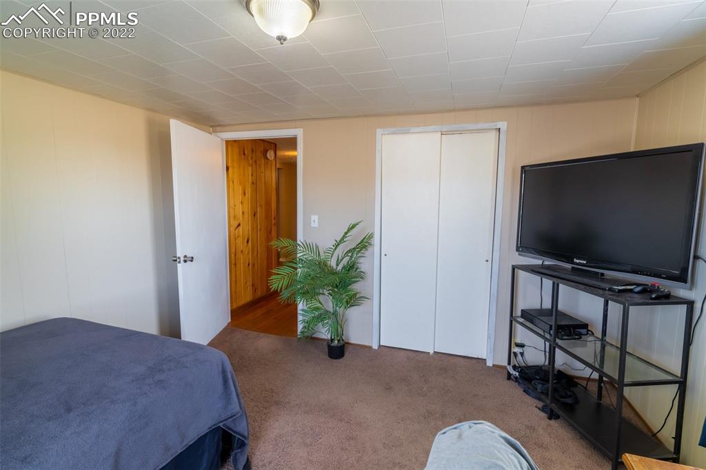 918 B Street Penrose, CO 81240 - Photo 15 of 23 a bedroom with a bed and a flat screen tv