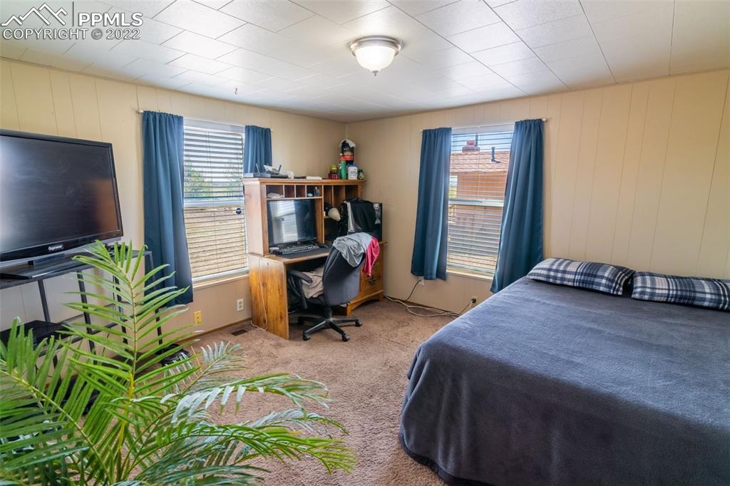 918 B Street Penrose, CO 81240 - Photo 16 of 23 a bed room with a bed and a flat screen tv