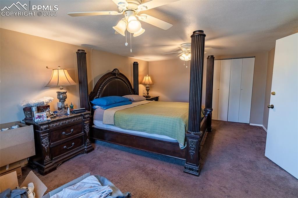 918 B Street Penrose, CO 81240 - Photo 17 of 23 a bedroom with a bed and a chandelier