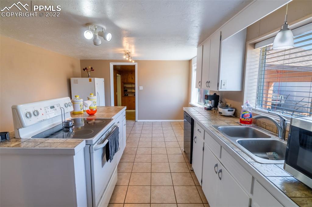 918 B Street Penrose, CO 81240 - Photo 22 of 23 a kitchen that has a sink and a stove