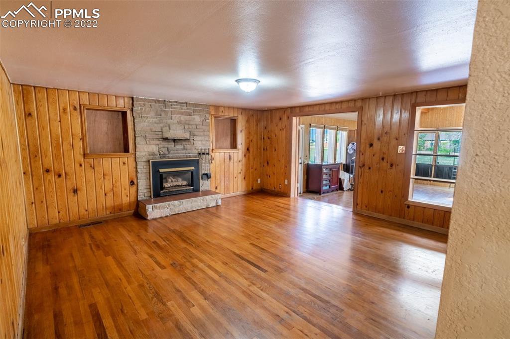 918 B Street Penrose, CO 81240 - Photo 10 of 23 an empty room with wooden floor and fireplace