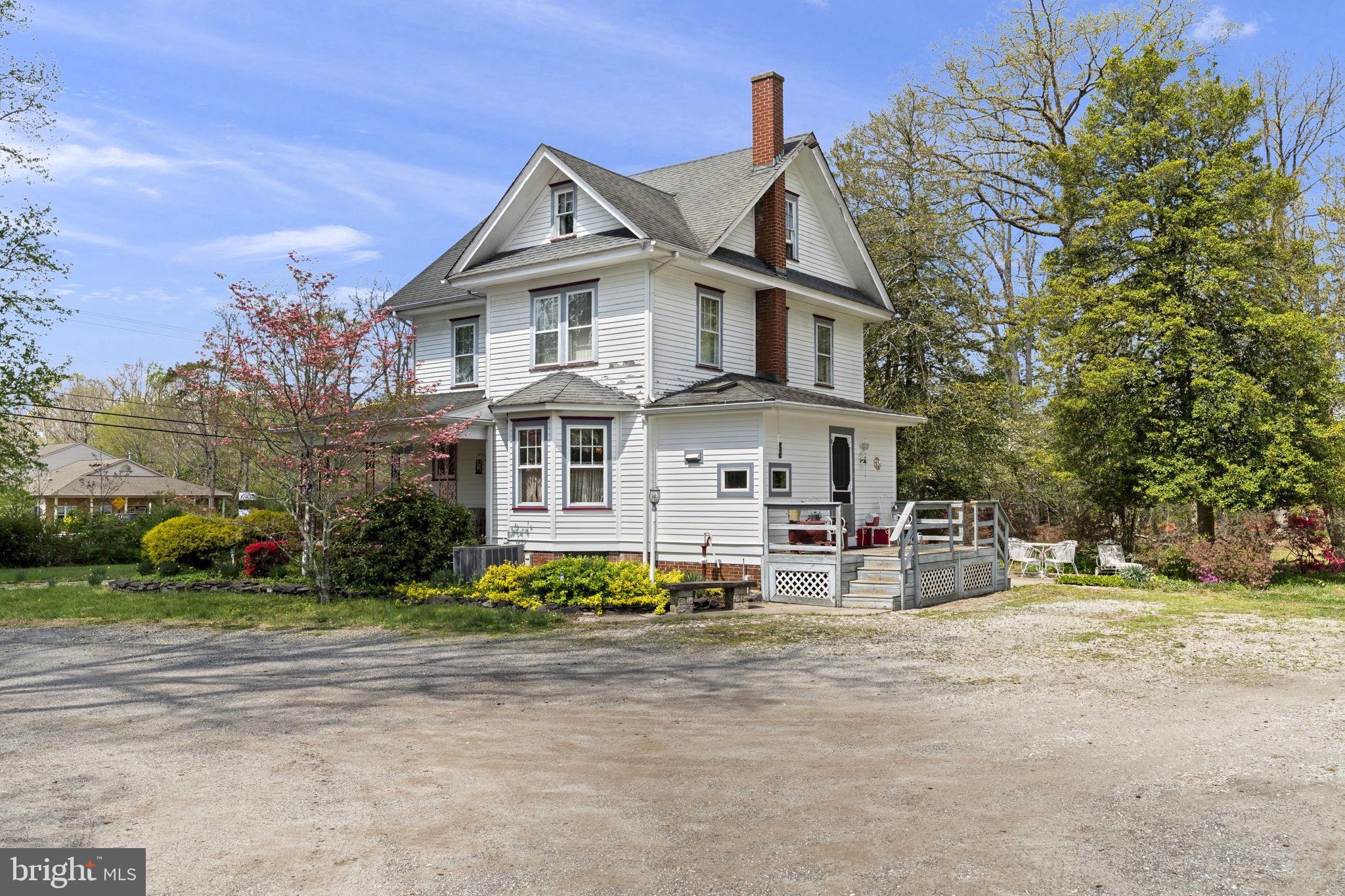 186 South Rte 73 Hammonton, NJ 08037 - Photo 4 of 38 a view of a white house with a large windows and a yard